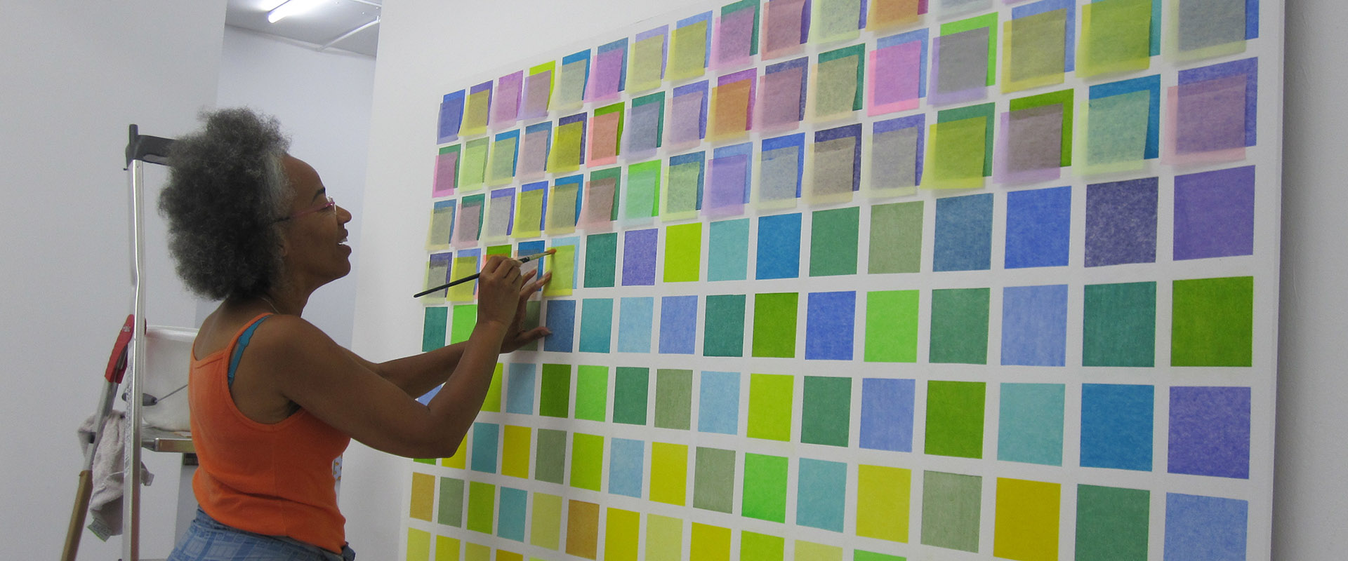 Jocelyn Santos installiert ihre Wandarbeit für die Ausstellung "Works on & with Paper", Galerie Renate Bender 2015